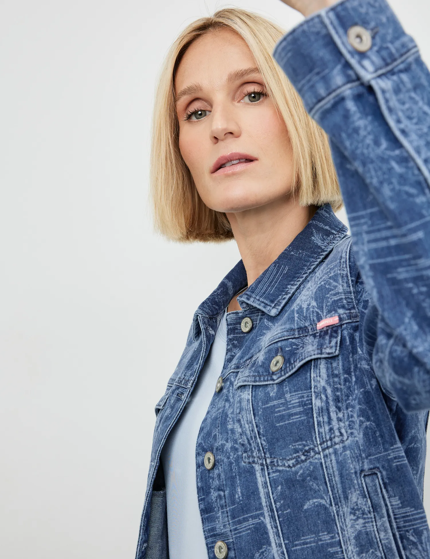 Denim jacket with a subtle palm tree design