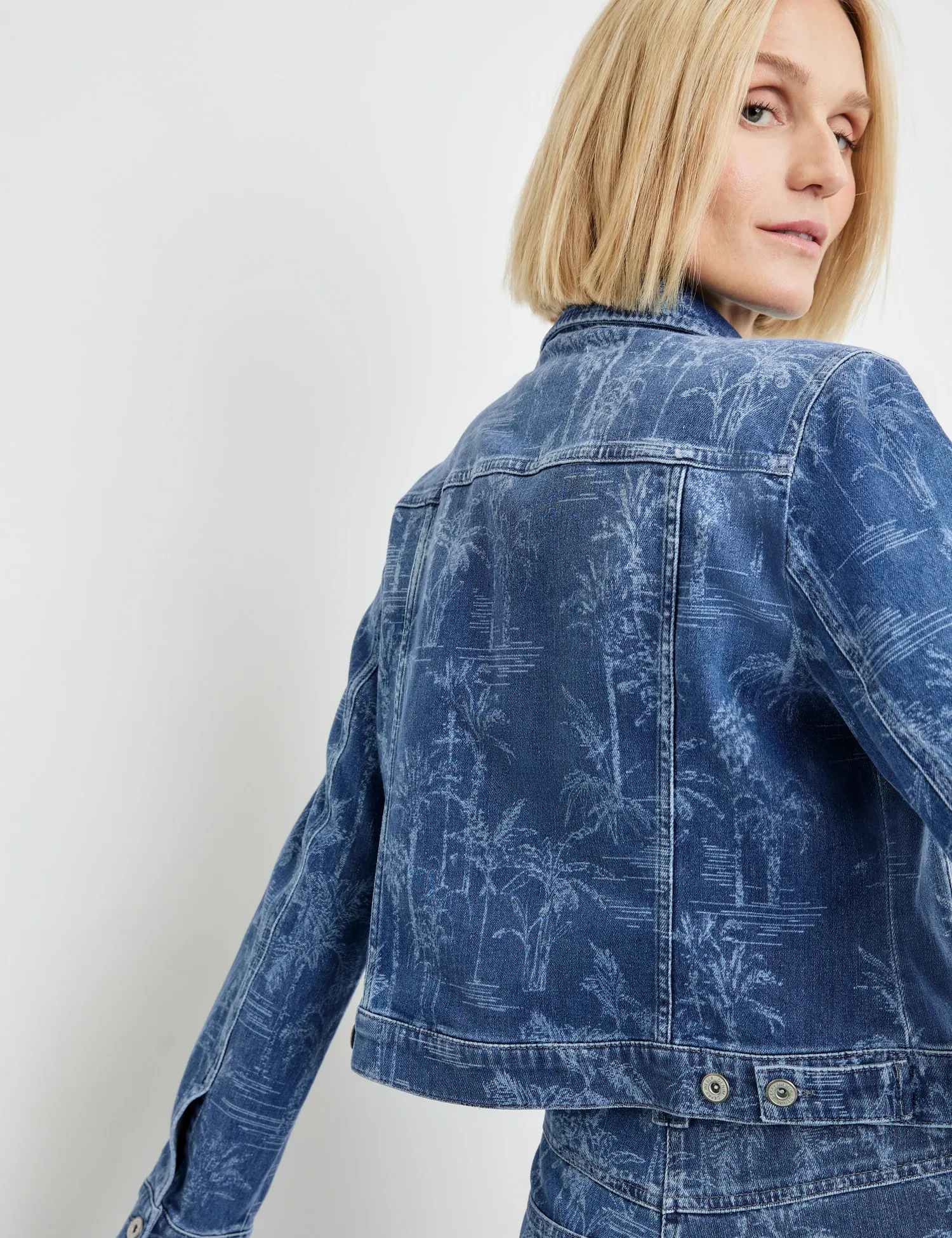 Denim jacket with a subtle palm tree design